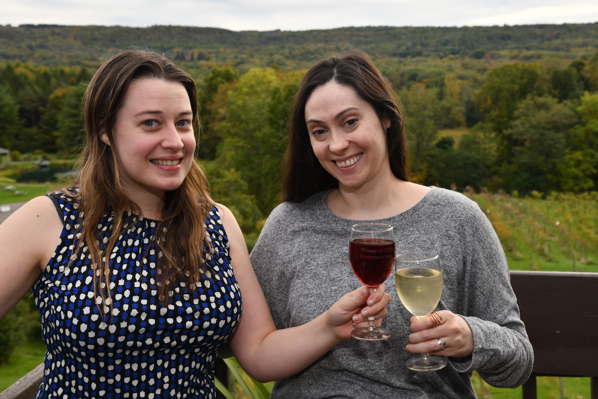 Rebekkah and Christina of Pour Somme clinking wine glasses